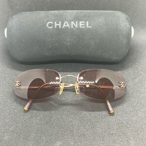Chanel rimless sunglasses with a brown tinted lens.